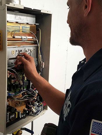 Plumber tuning up water heater