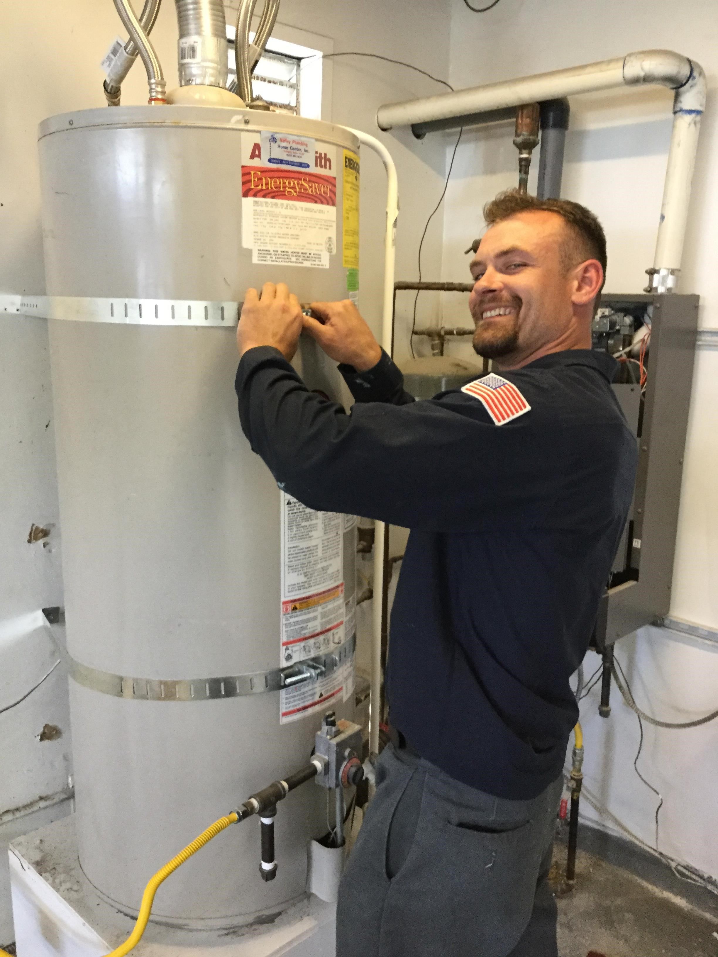 technician in Oakland fixing a water heater